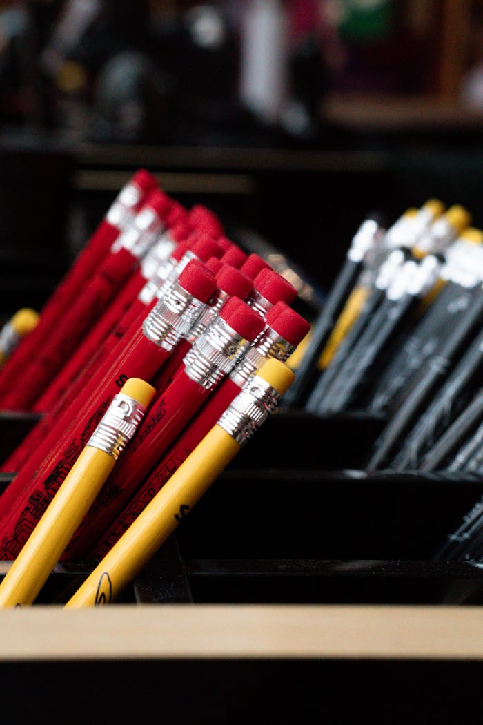 about-img Close-up of red and yellow pencils in containers, offering vibrant stationery organization inspiration.